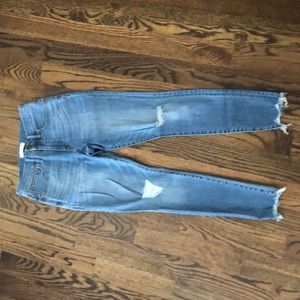 Light wash, ripped knee skinny jeans.